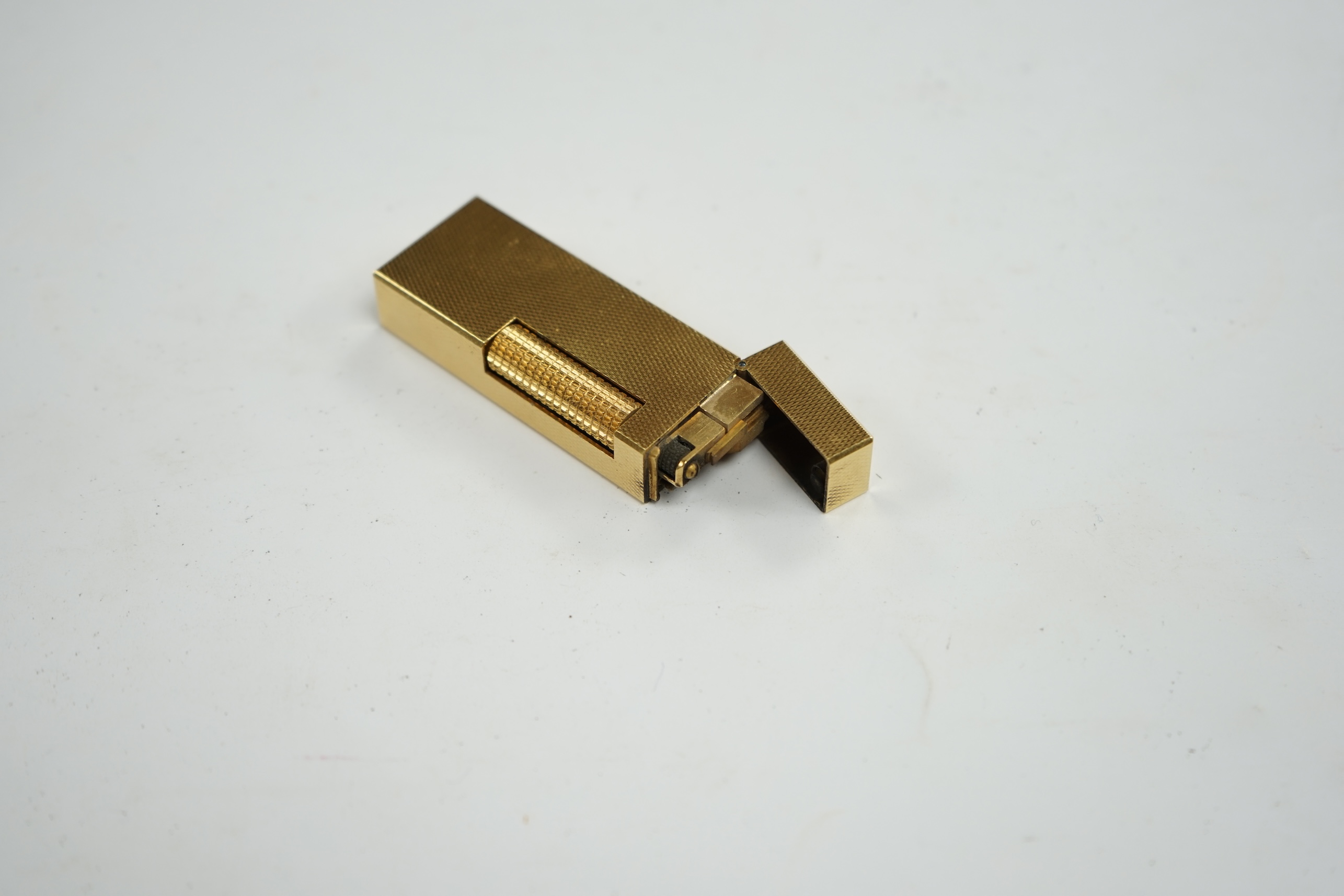 A cased gilt metal Dunhill ‘Rollagas’ lighter, 6.5cm high. Condition - some slight marks to case